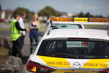 Photo taken from behind a cop car of a woman being pulled over