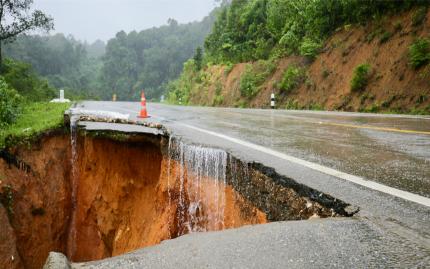 Extreme weather has caused a chunk of road to slip away.