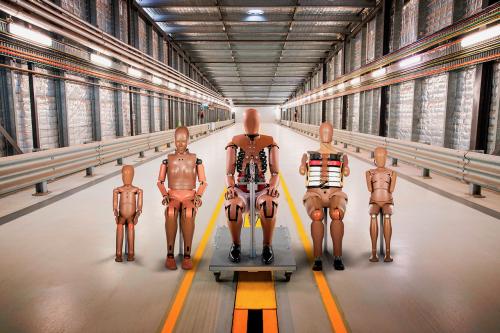 A line up of crash test dummies in different body sizes.