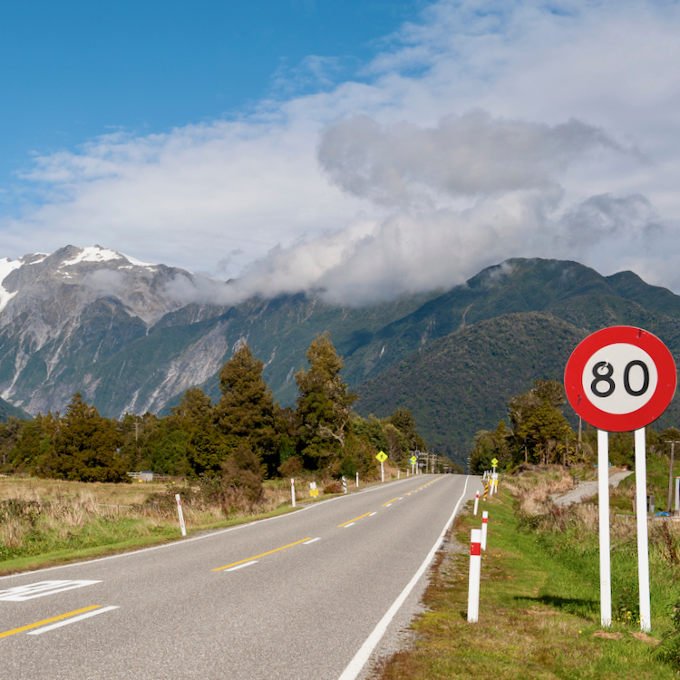 New Zealand road with 80km/h sign.