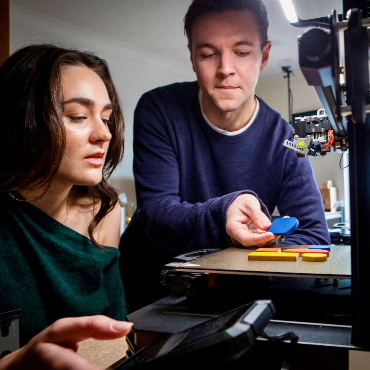 Courtney Naismith and Matthew O'Hagen using their 3D printer at Utilize Studios.