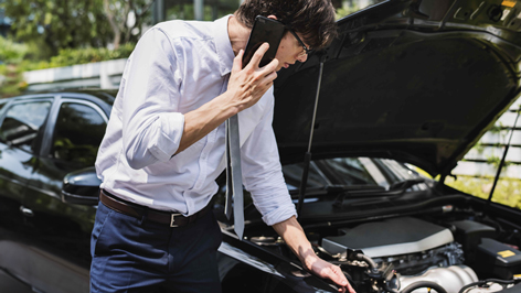 Driver looking under bonnet