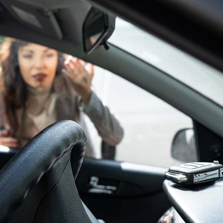 A woman looking confused while she is locked outside of her car